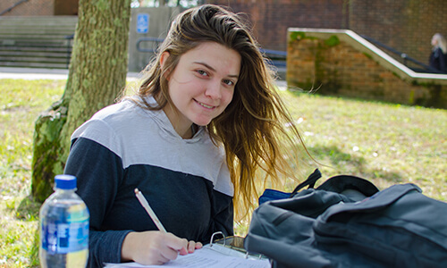 Student outdoors on the West Barnstable campus